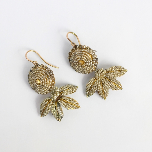 271 - A pair of 18th century seed pearl earrings, the circular bombe seed pearl centre suspending a stylis... 