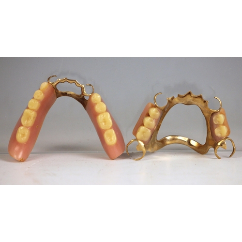 272 - A set of early 20th century false teeth or dentures, with gold coloured mounts (2)
