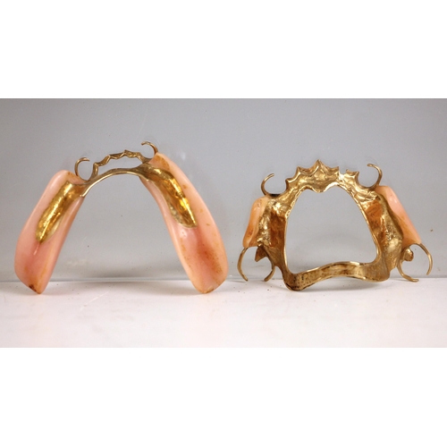 272 - A set of early 20th century false teeth or dentures, with gold coloured mounts (2)