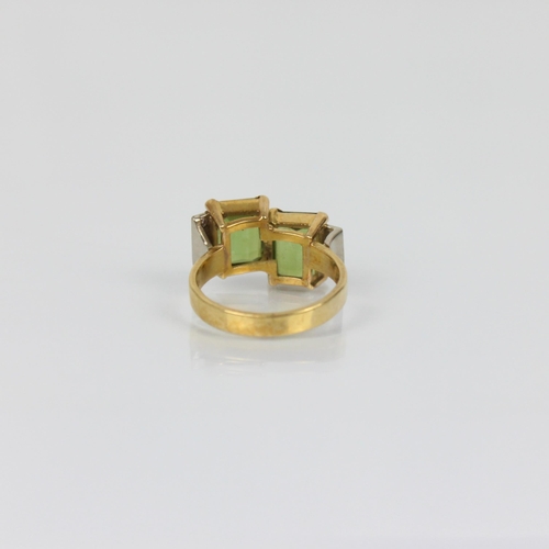 178 - A late 20th century green tourmaline and diamond ring, the two emerald cut green tourmalines set in ... 