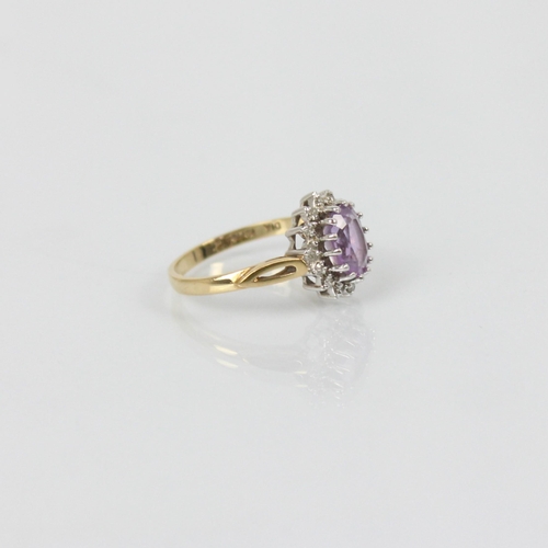 215 - An amethyst and diamond dress ring, the central oval amethyst within surround of diamonds in cluster... 