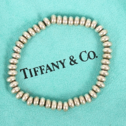 243 - A Tiffany and Co silver bracelet, the beaded bracelet stamped ‘T&Co 925' 34gms, within associated Ti... 