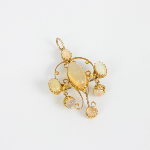 245 - An early 20th century yellow metal 'jelly opal' coloured pendant/brooch, the central oval cabochon w... 