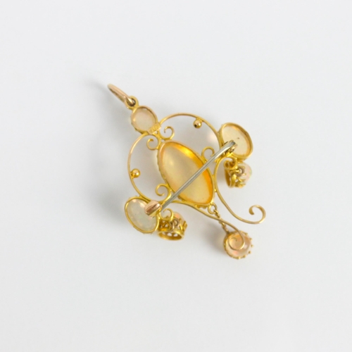245 - An early 20th century yellow metal 'jelly opal' coloured pendant/brooch, the central oval cabochon w... 