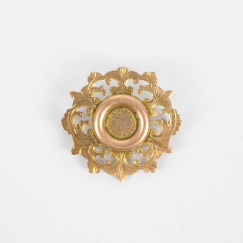 248 - An early 20th century 9ct gold presentation badge, of shaped circular form with openwork and engrave... 