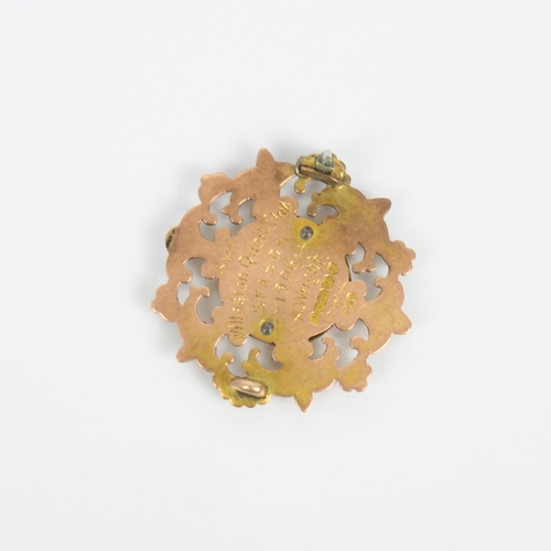248 - An early 20th century 9ct gold presentation badge, of shaped circular form with openwork and engrave... 