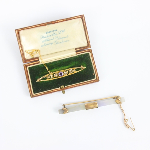 251 - An early 20th century amethyst and seed pearl bar brooch, of openwork lozenge shape with central rou... 