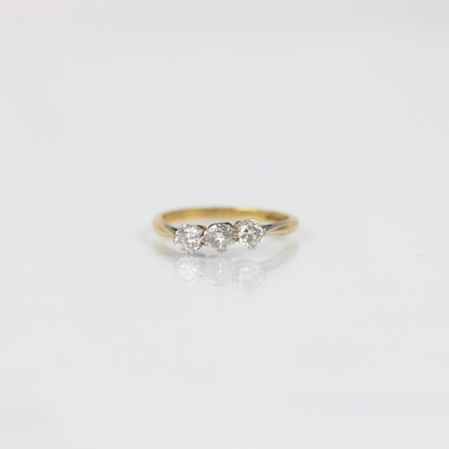 258 - A mid 20th century diamond three stone ring, the three graduated round cut diamonds in white metal s... 