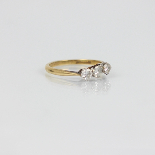 258 - A mid 20th century diamond three stone ring, the three graduated round cut diamonds in white metal s... 