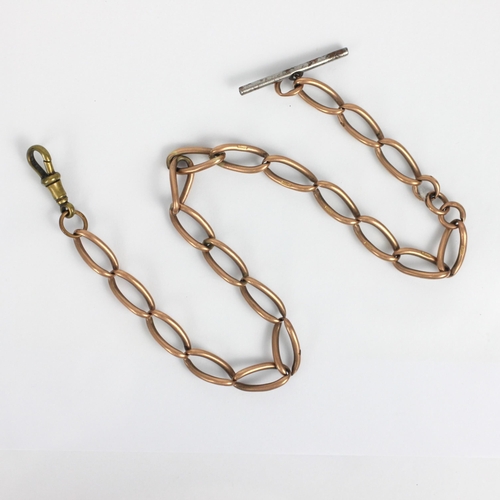 262 - An early 20th century yellow metal part watch chain, the stylised elongated curb link chain stamped ... 
