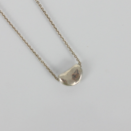 264 - A Tiffany and Co 'Bean' silver necklace, designed by Elsa Peretti, the bean shaped pendant stamped t... 