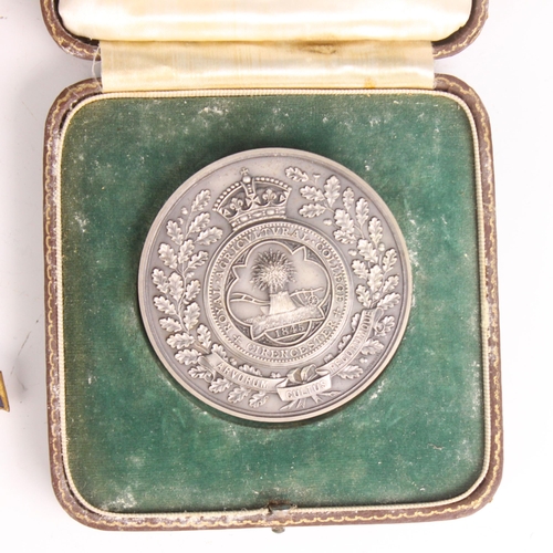 145 - A Cirencester 'Goldstand silver' medal, for the student of the year, within case (at fault) with a c... 