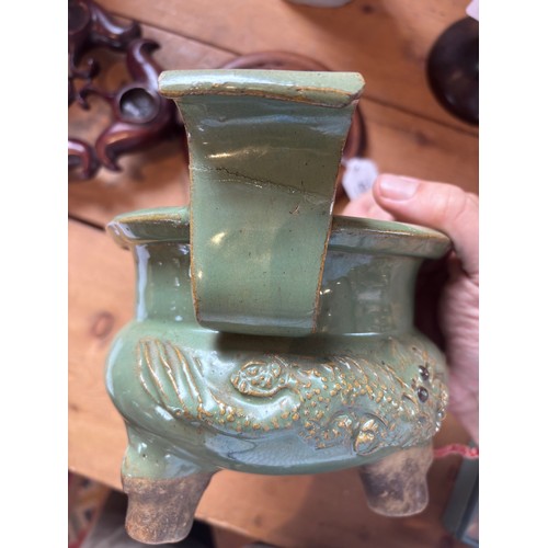 439 - A large Chinese Longquan celadon glazed incense burner, the koro of cauldron form with two scroll ha... 