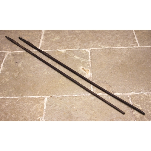 465 - A pair of Nigerian Yoruba staffs, each terminal carved with a standing figure above a square section... 