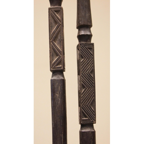 465 - A pair of Nigerian Yoruba staffs, each terminal carved with a standing figure above a square section... 