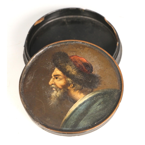 274 - A black lacquered papier mache portrait snuff box and cover, 19th century, the cover painted with a ... 