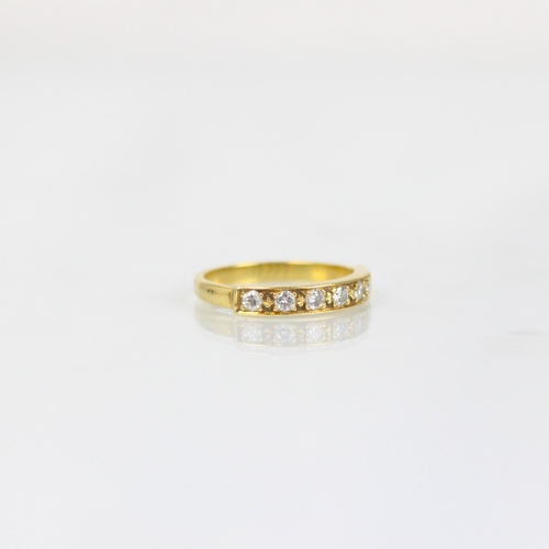 268 - A late 20th century diamond half eternity ring, the seven round cut diamonds in a milgrain setting e... 