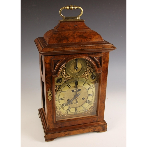 A George II and later figured walnut bracket clock, the caddy shaped ...
