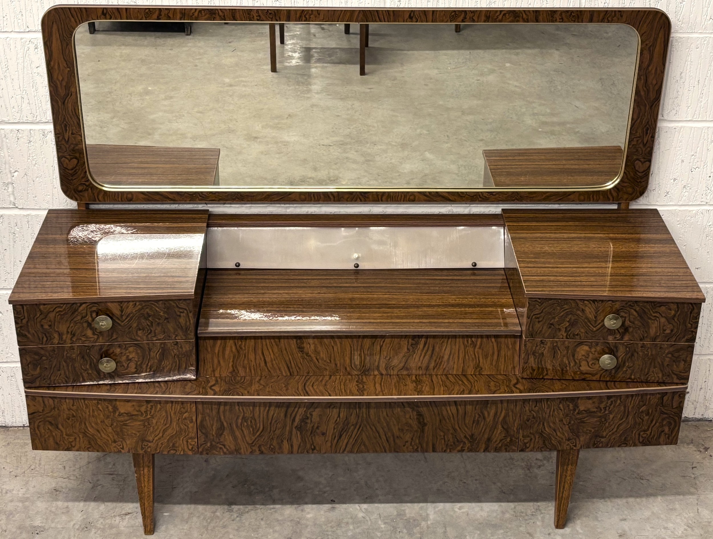 A 1970's rosewood effect Beautility dressing table, the rectangular ...