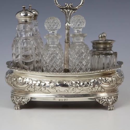 60 - A George IV silver cruet stand, J E Terrey & Co, London 1820, the acanthus capped handle above eight... 