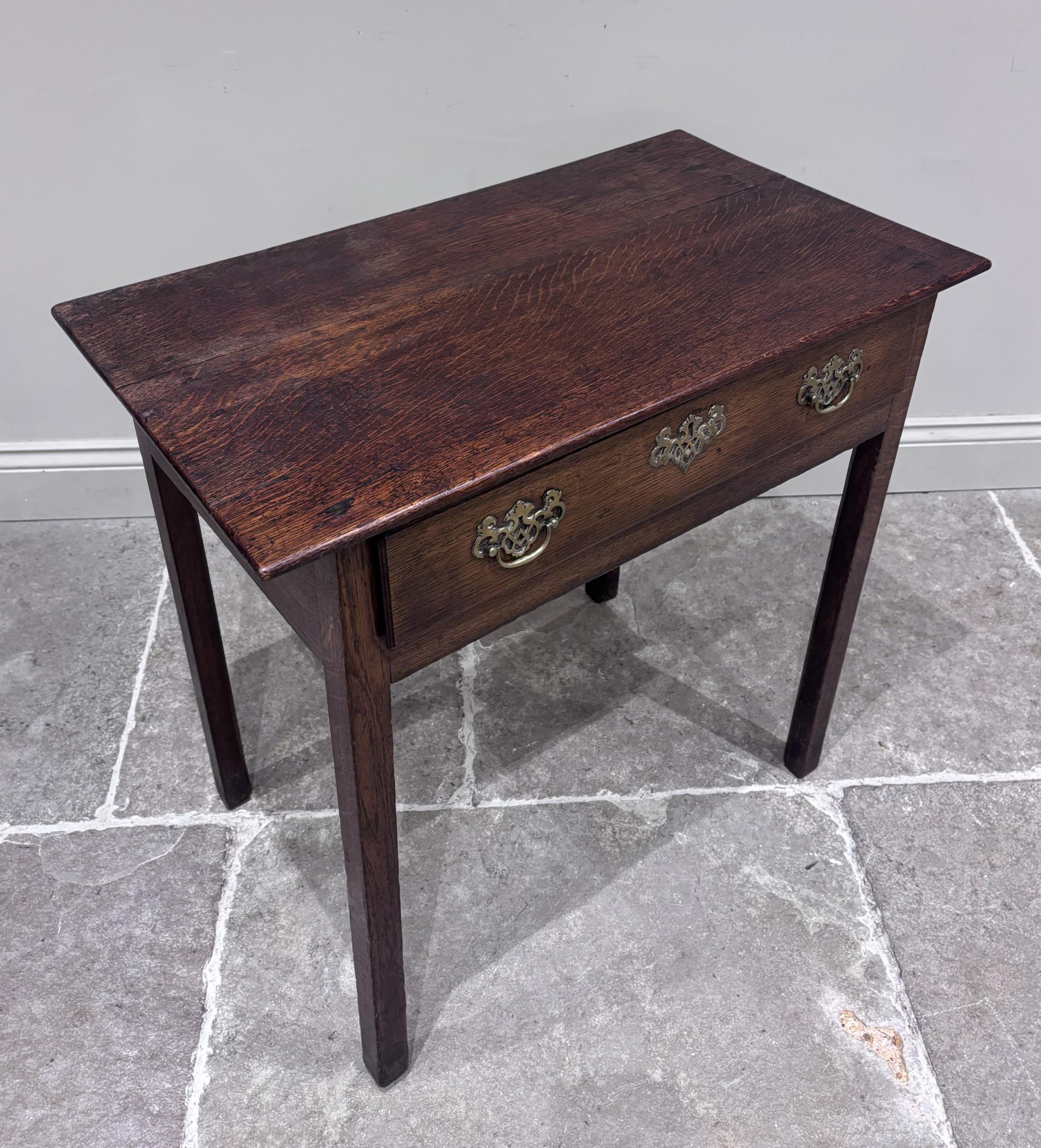 A George III oak lowboy, the rectangular top above a single frieze ...