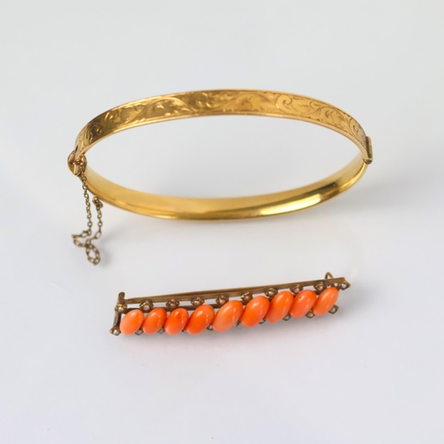 106 - An early 20th century style gold plated bangle, with florally engraved front leading to plain polish... 