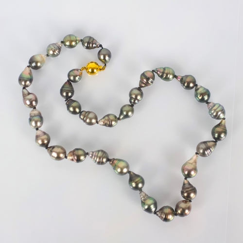 107 - A strand of Tahitian cultured pearls, the thirty three non uniform cultured pearls with box and tong... 
