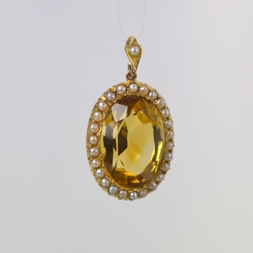 109 - An early 20th century citrine pendant, the oval cut citrine within a seed pearl border with conformi... 