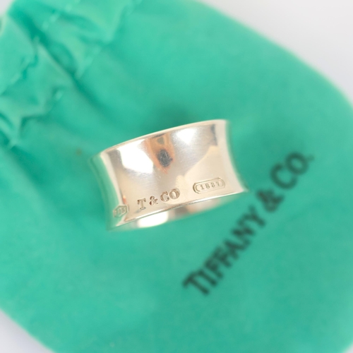 112 - A late 20th century Tiffany and Co '1837' ring, the wide concave ring stamped 'T&Co 925 1837' ring s... 
