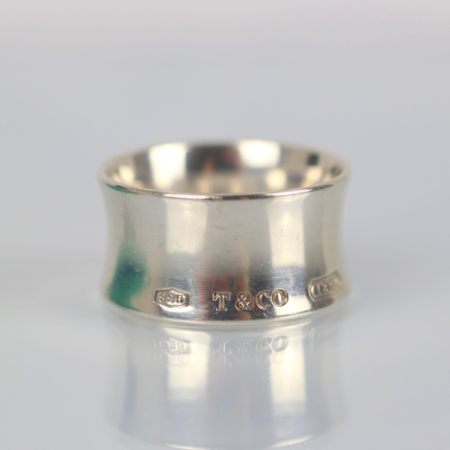 112 - A late 20th century Tiffany and Co '1837' ring, the wide concave ring stamped 'T&Co 925 1837' ring s... 