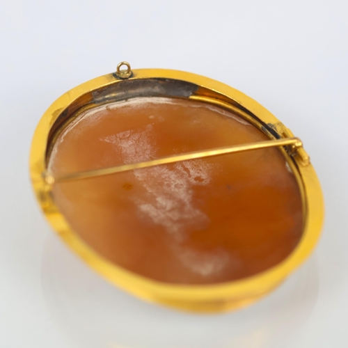 115 - A 19th century Italian cameo brooch, the central oval depiction of the Madonna with child, within a ... 