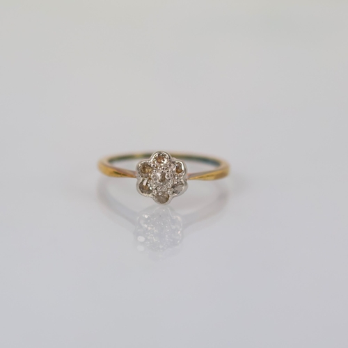118 - An early 20th century diamond cluster ring, the old cut diamond within surround of six smaller old c... 