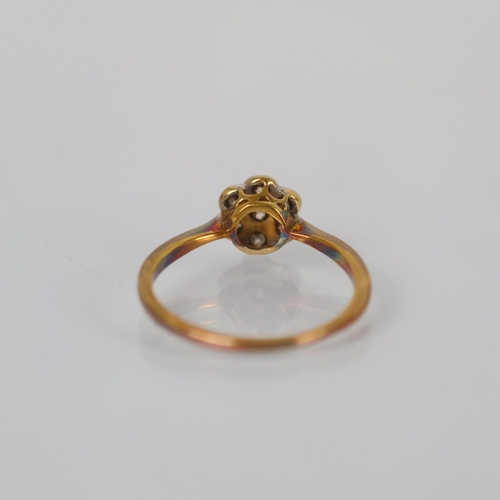 118 - An early 20th century diamond cluster ring, the old cut diamond within surround of six smaller old c... 