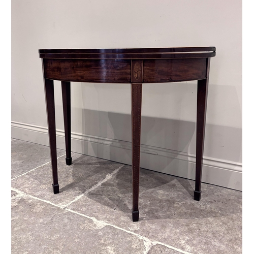 550 - A Regency mahogany and satinwood inlaid demi-lune tea table, the fold-over top raised on four legs o... 