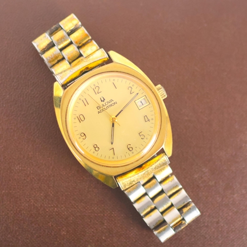 82 - A mid 20th century Bulova Accutron wristwatch, the circular gold coloured dial with Arabic numerals ... 