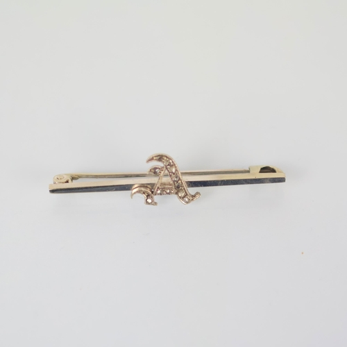 96 - An early 20th century diamond brooch, the 'A' initial set with rose cut diamonds, upon a plain polis... 