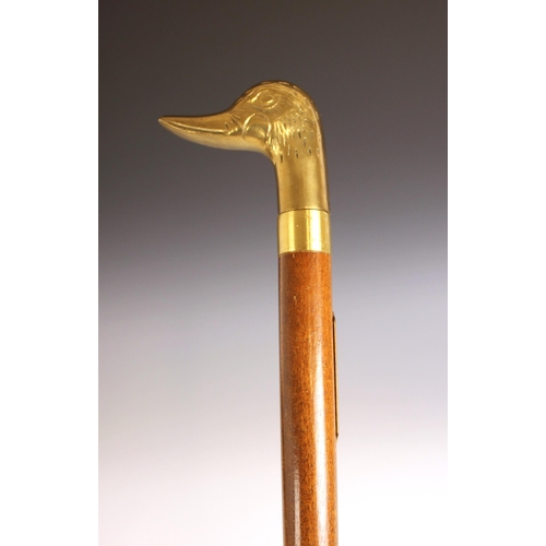 390 - A brass mounted tippling cane or tippler, early 20th century, the handle modelled as a duck's head c... 