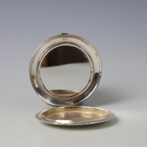 23 - A George V silver mounted compact, 'SF' London 1933, of circular form with all over engine turned de... 