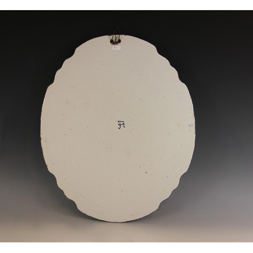 309 - A Tichelaar Makkum Delft blue and white wall plaque, 20th century, of shaped oval form with raised r... 