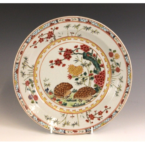 334 - A Chinese porcelain famille rose plate, 18th century style, the shallow circular plate painted to th... 
