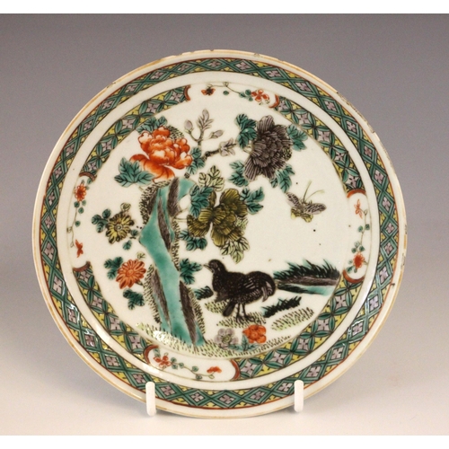 339 - A Chinese porcelain famille verte saucer dish, 18th century, the small circular dish painted to the ... 