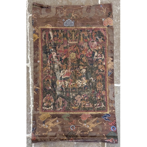 415 - A South East Asian Tibetan Thangka, 19th century, painted in gouache against a silk and metallic gro... 
