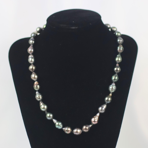 107 - A strand of Tahitian cultured pearls, the thirty three non uniform cultured pearls with box and tong... 