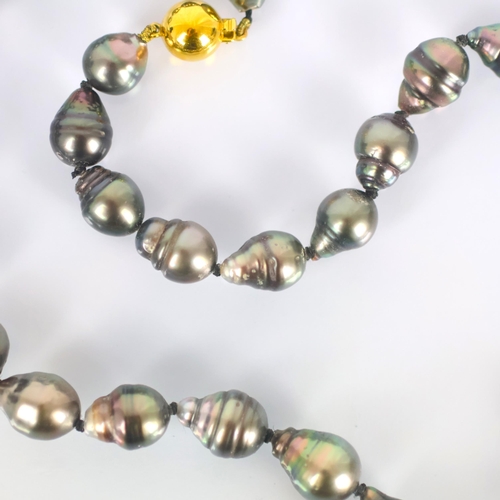 107 - A strand of Tahitian cultured pearls, the thirty three non uniform cultured pearls with box and tong... 