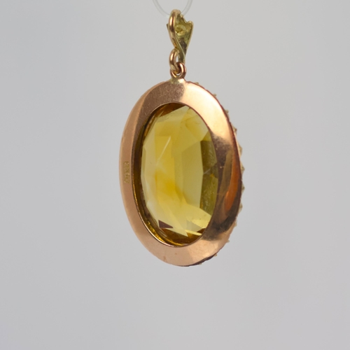109 - An early 20th century citrine pendant, the oval cut citrine within a seed pearl border with conformi... 
