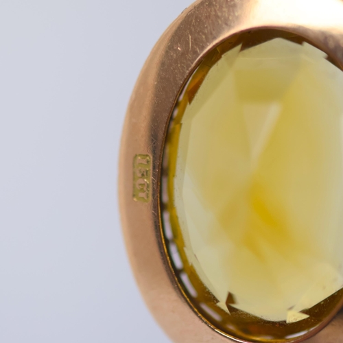 109 - An early 20th century citrine pendant, the oval cut citrine within a seed pearl border with conformi... 