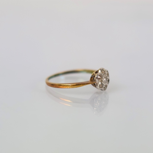 118 - An early 20th century diamond cluster ring, the old cut diamond within surround of six smaller old c... 