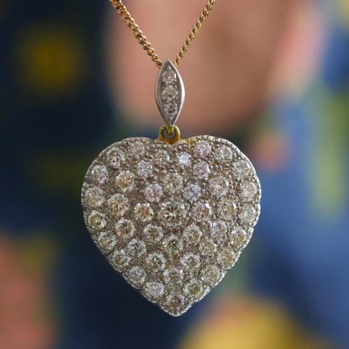 120 - A mid 20th century diamond heart pendant, the pendant set with forty six graduated round cut diamond... 