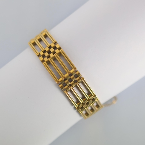 124 - A late 20th century 9ct gold bracelet, the stylised gate link bracelet suspending a heart shaped pad... 