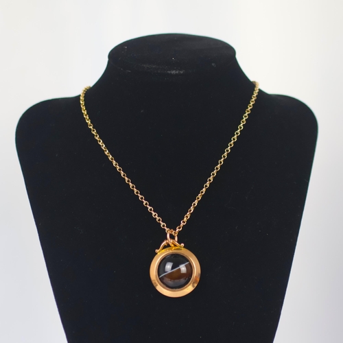 126 - A late 19th century banded agate pendant, the circular cabochon within plain polished mount, marked ... 